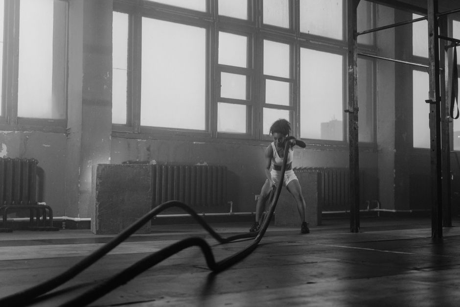 An athlete mid-sprint during a conditioning session, captured in black and white.